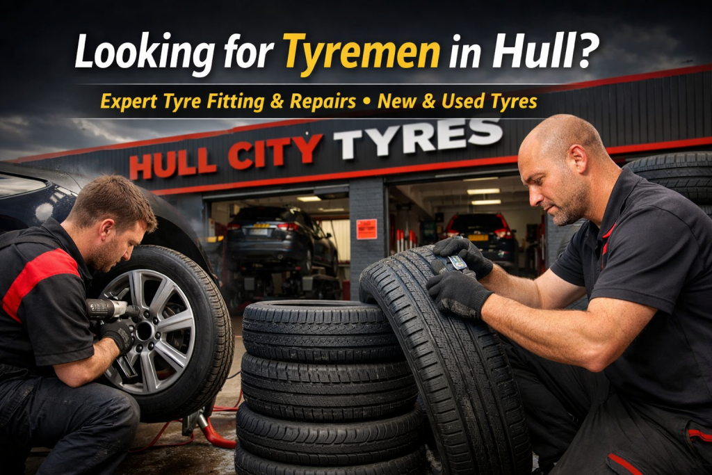 Image showing men fixing tyres as tyre men